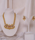 Elegant gold necklace and earrings set with red and green gemstones, perfect for traditional occasions.