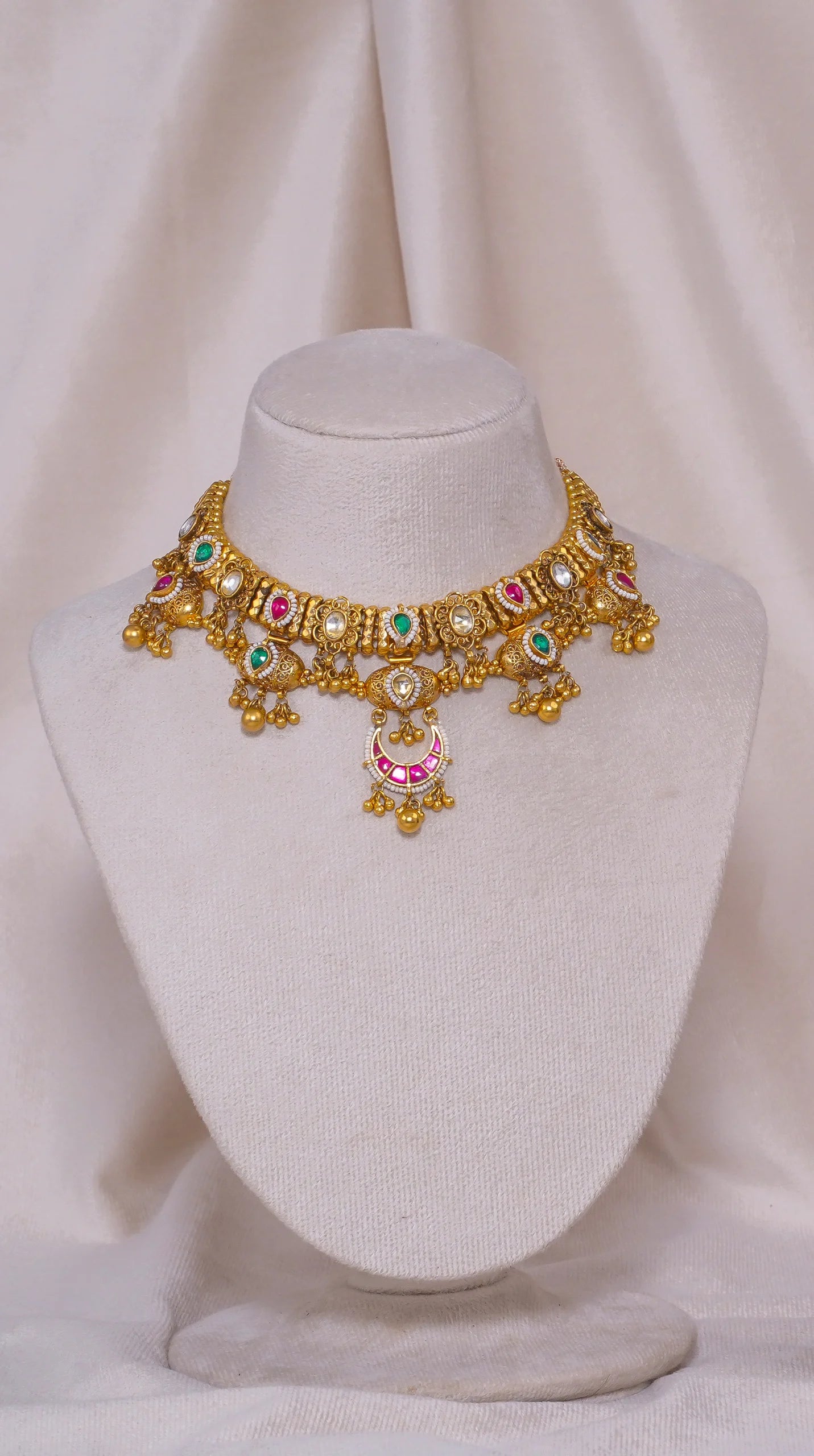 Elegant gold choker necklace with colorful gemstones and intricate designs
