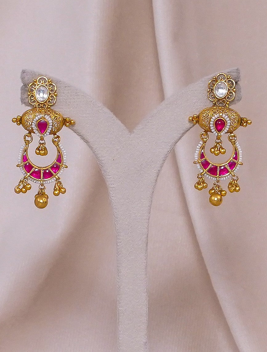 Elegant gold earrings with pink gemstones and intricate detailing