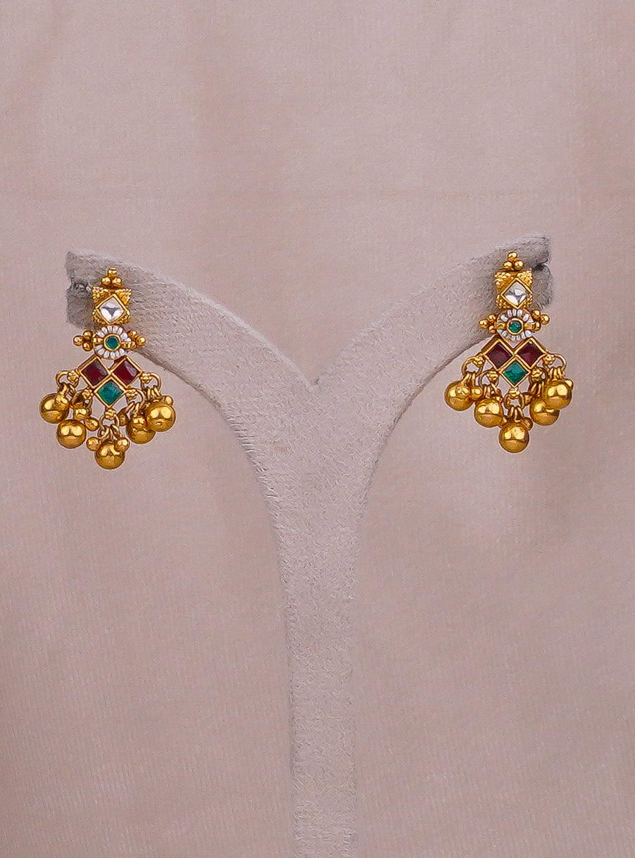 Gold jhumka earrings with red and green gemstones, traditional Indian jewelry design