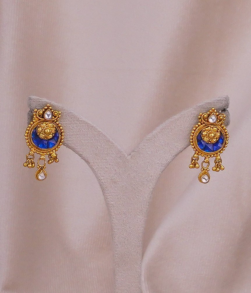 Elegant gold earrings with blue gemstones and dangling accents