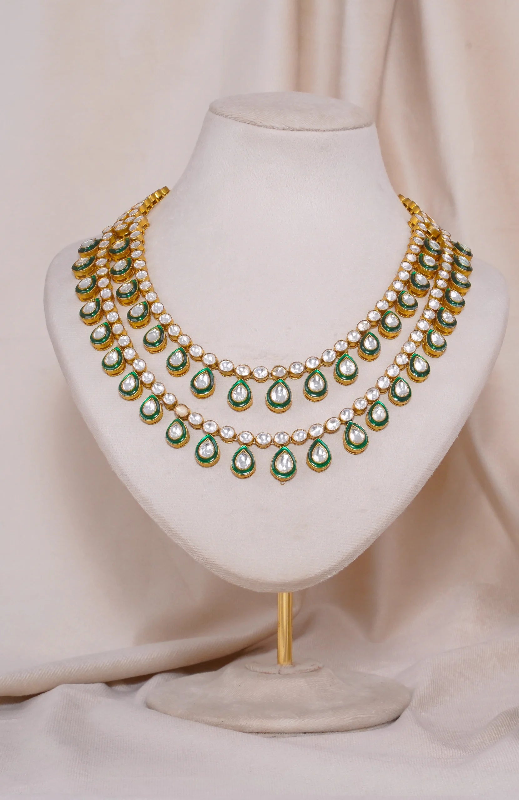 Gold kundan necklace with green enamel and white stones, traditional Indian bridal jewelry