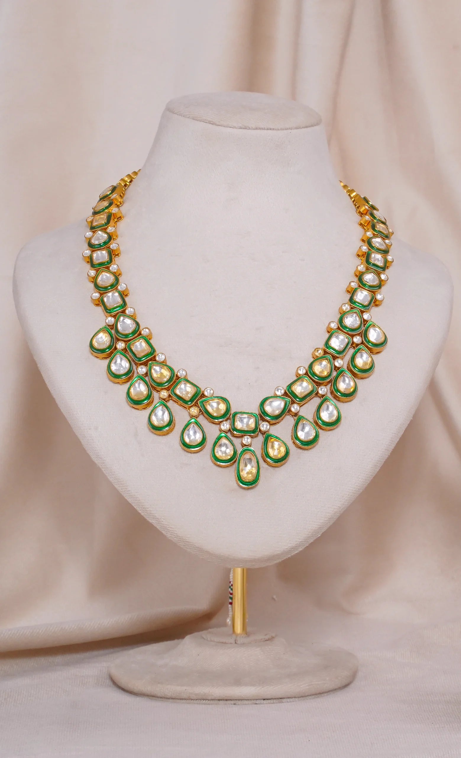 Gold kundan necklace with green enamel and pearl accents, traditional Indian bridal jewelry