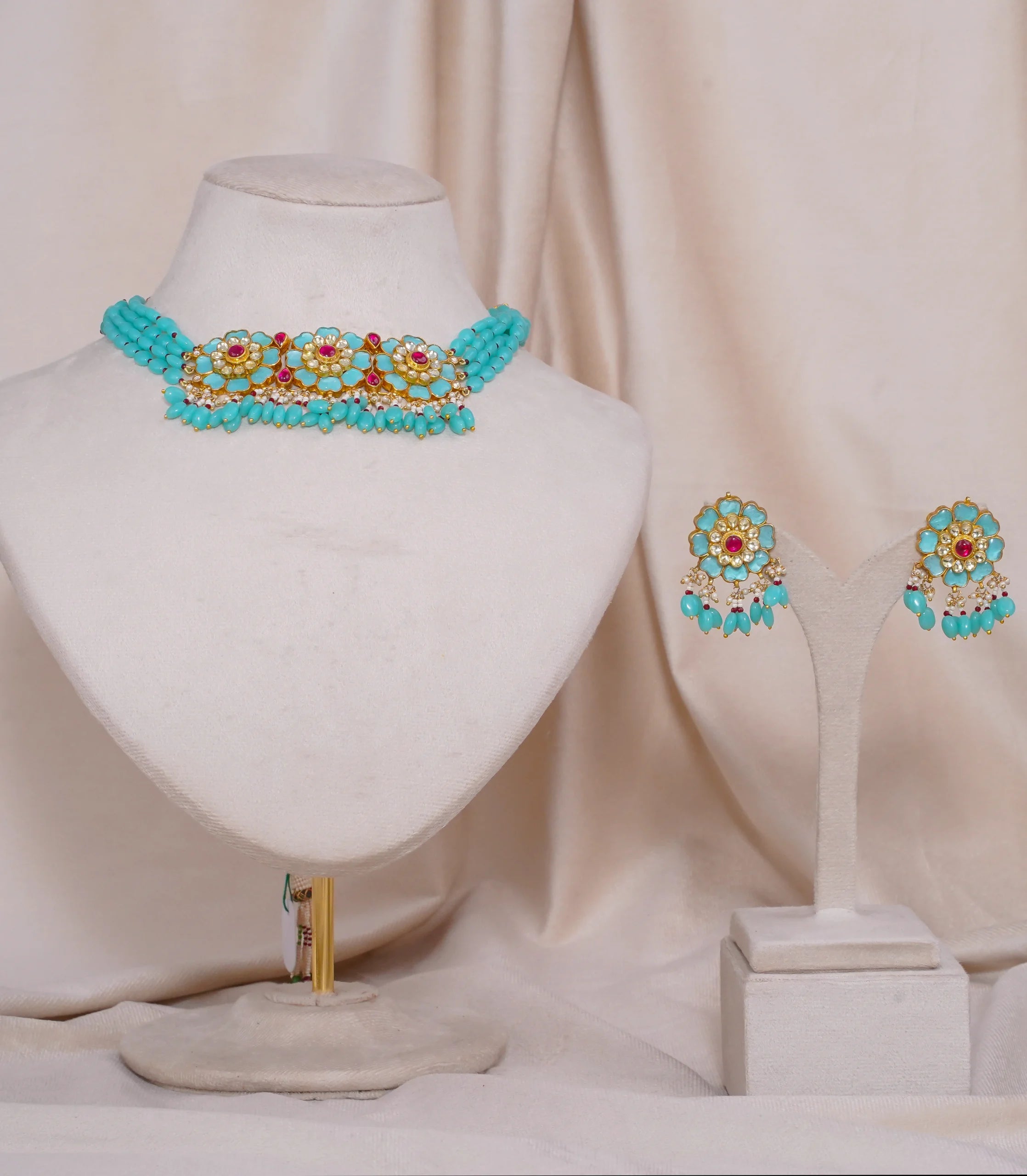 Turquoise and gold floral choker necklace with matching earrings, featuring red gem accents and pearl details.
