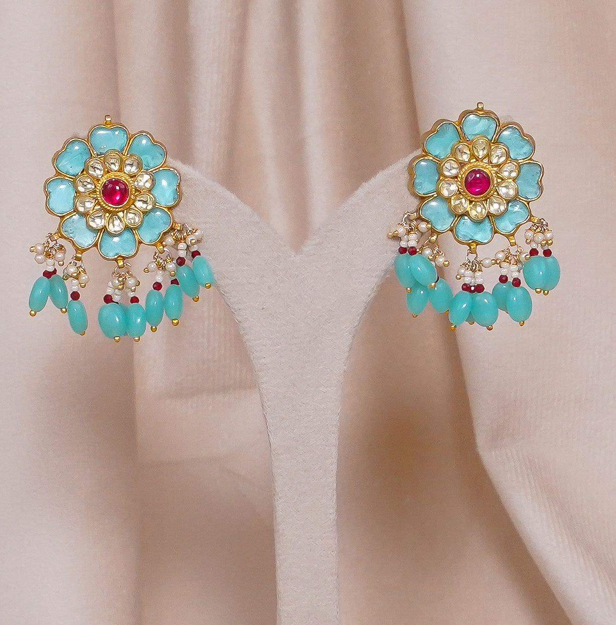 Turquoise flower earrings with red center, gold detailing, and dangling beads for ethnic wear