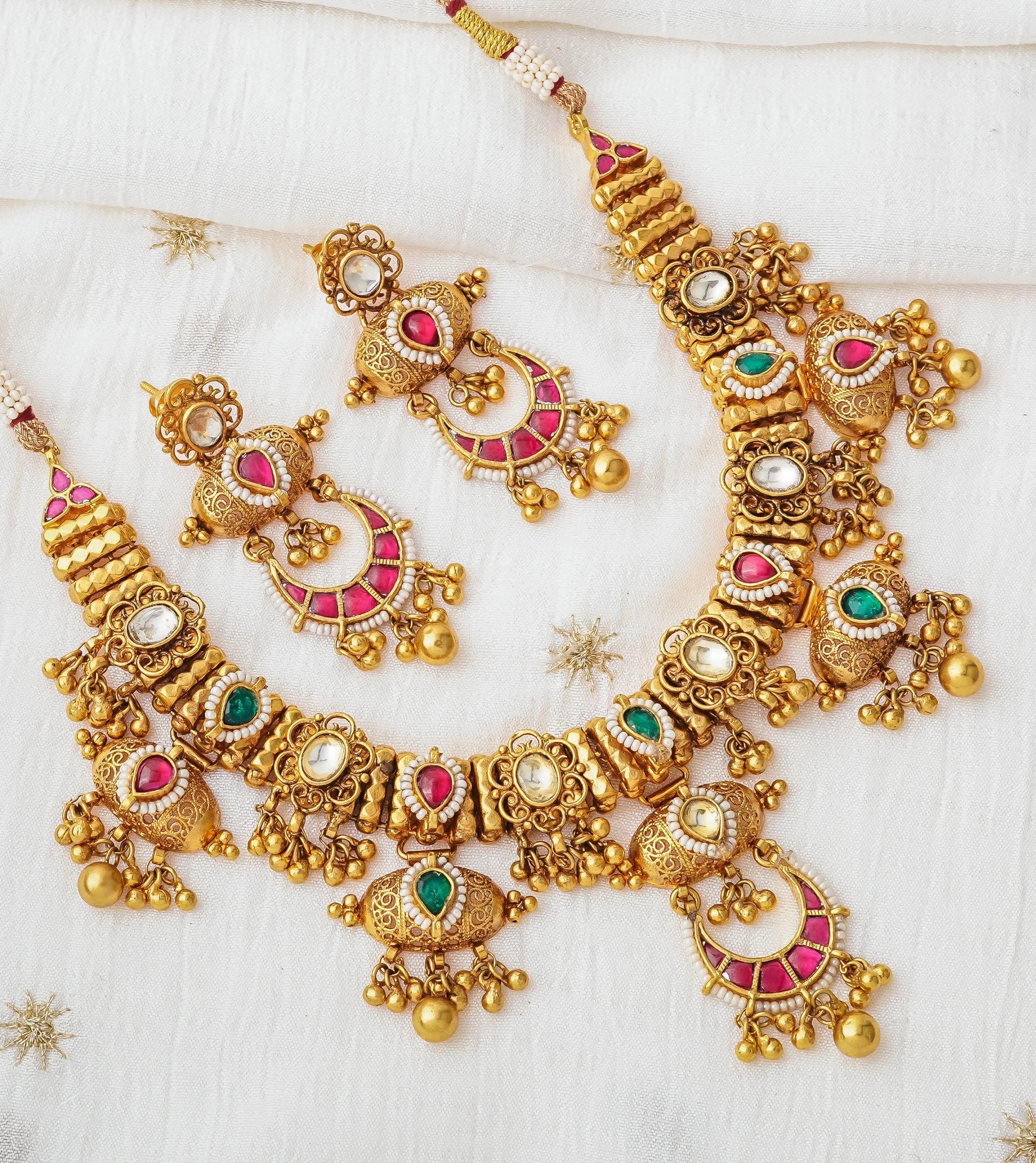 Elegant gold necklace set with pink and green gemstones, perfect for traditional occasions