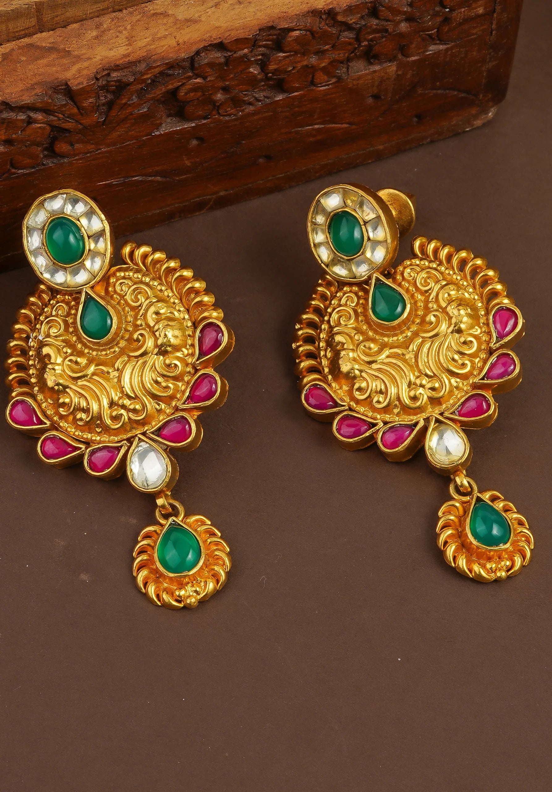 Elegant gold earrings with green and pink gemstones, intricate filigree design, traditional Indian jewelry style