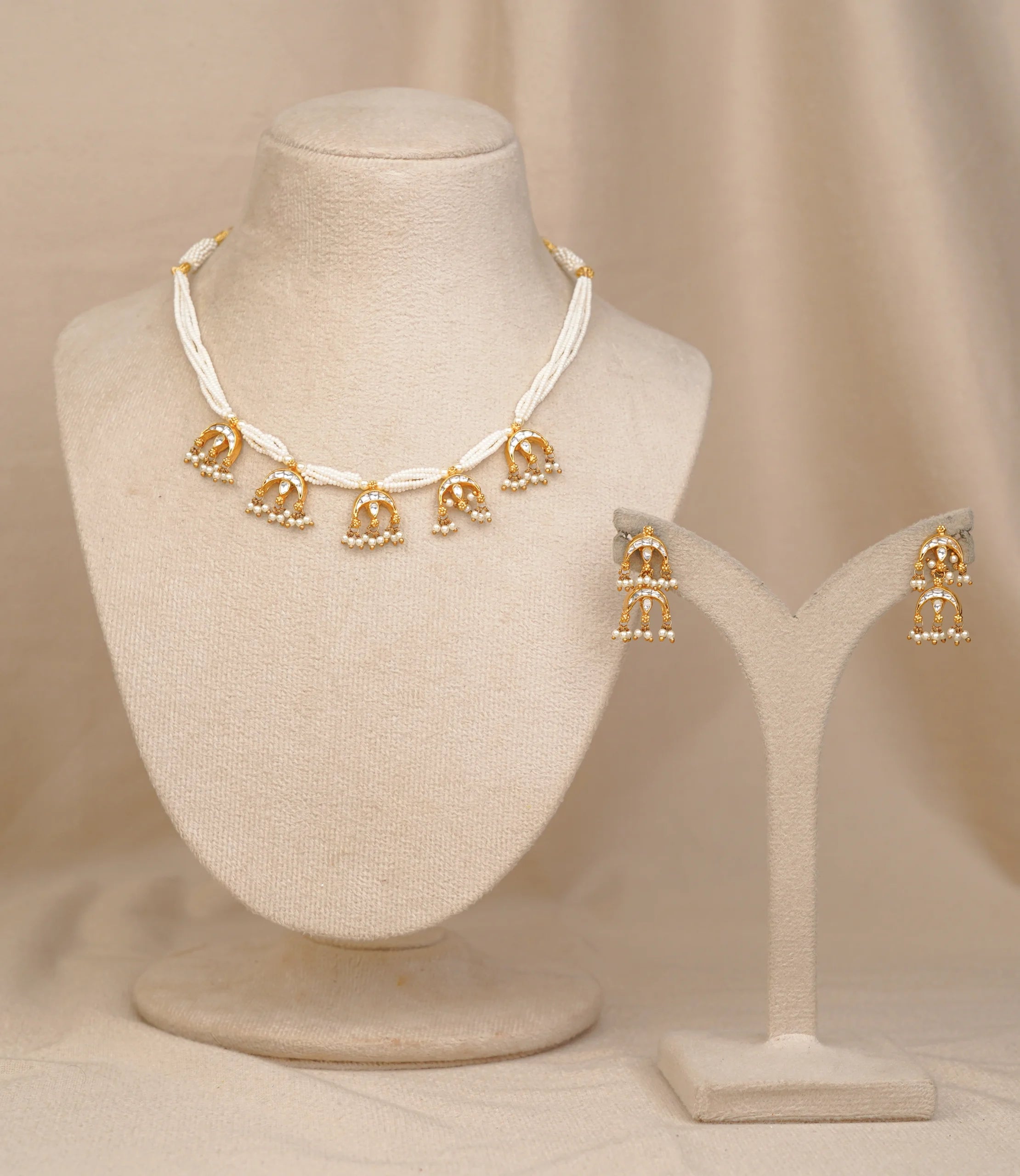 Gold and pearl choker necklace with matching jhumka earrings, elegant traditional jewelry set