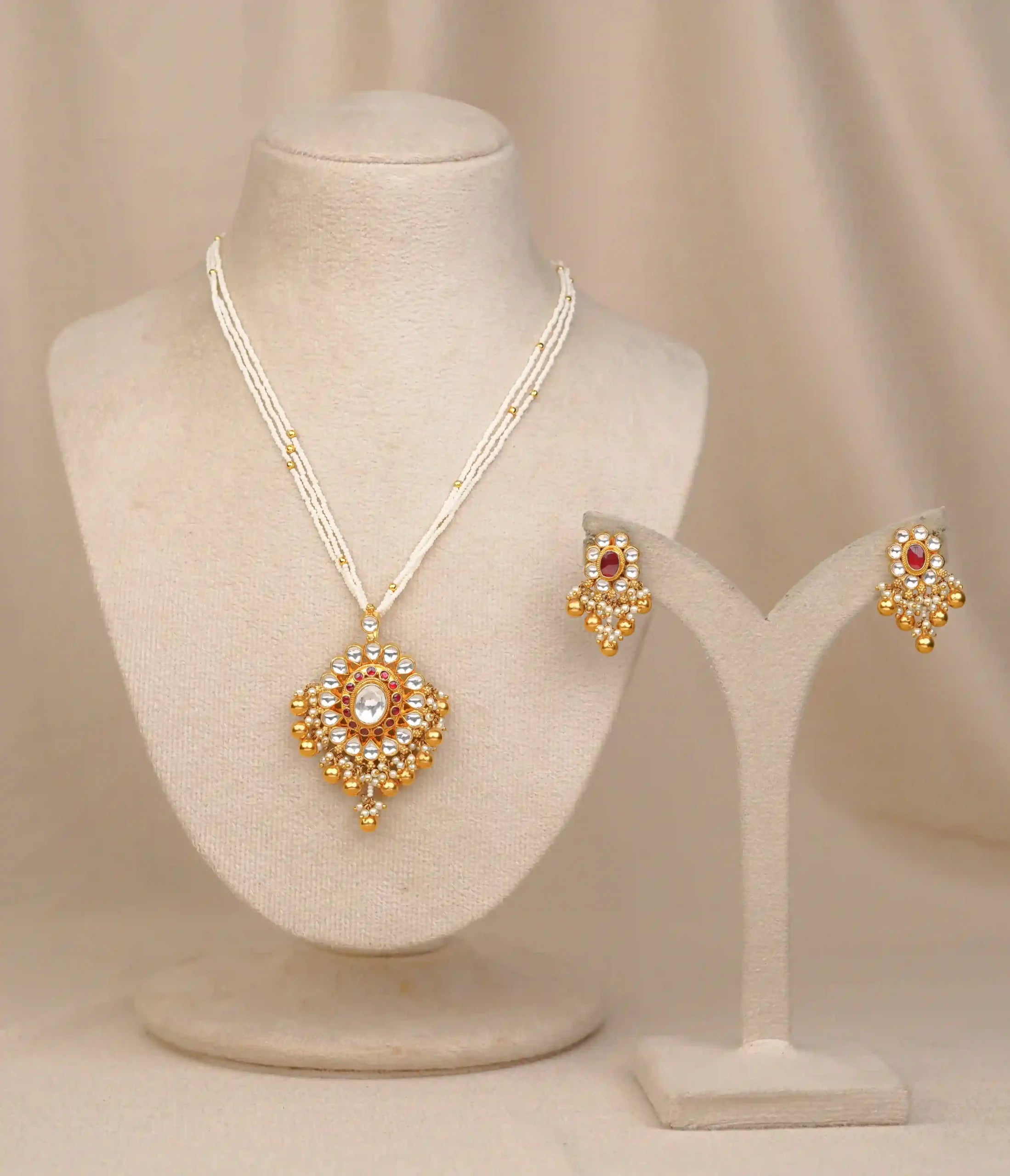 Gold kundan necklace set with white beads and matching earrings, traditional Indian jewelry design