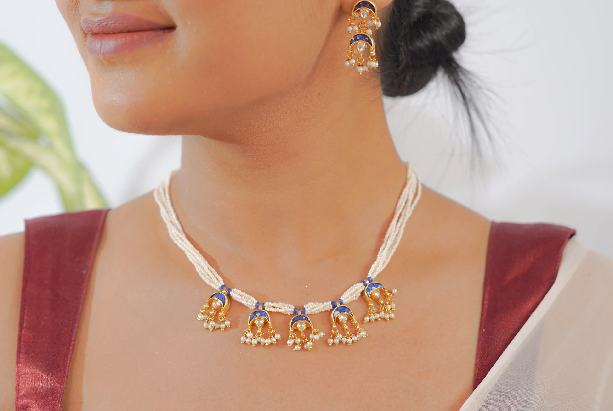 Gold temple jewelry set with blue enamel and pearls, traditional Indian necklace and earrings