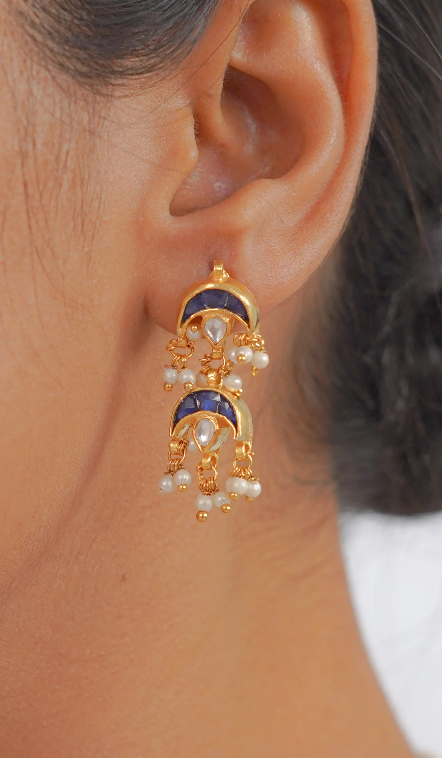 Gold jhumka earring with blue stones and pearl drops, traditional Indian jewelry design