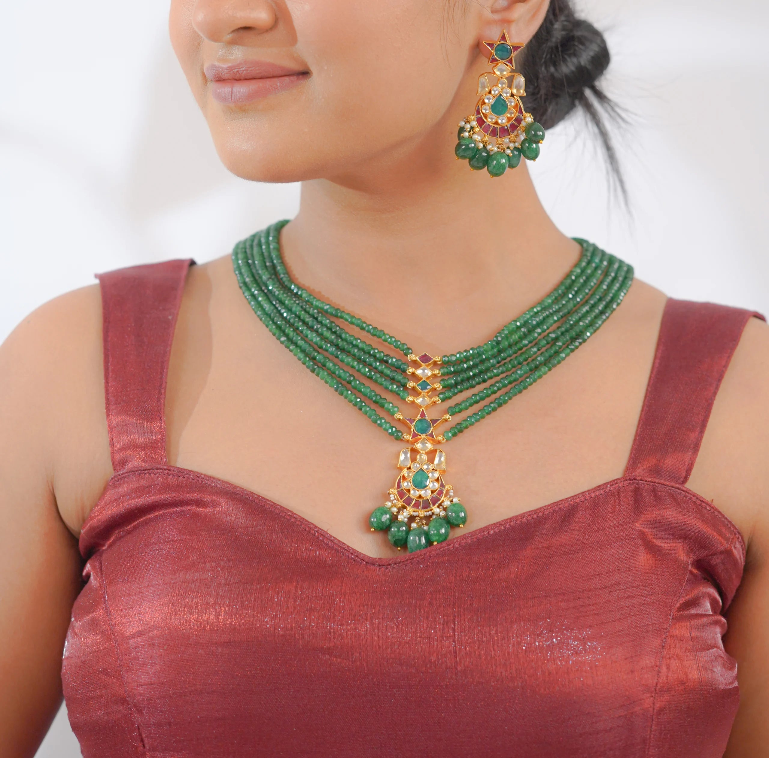 Emerald and gold traditional necklace set with matching earrings, perfect for Indian bridal wear